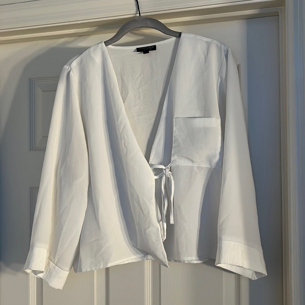 White 3/4 length sleeve top with tie front and pocket